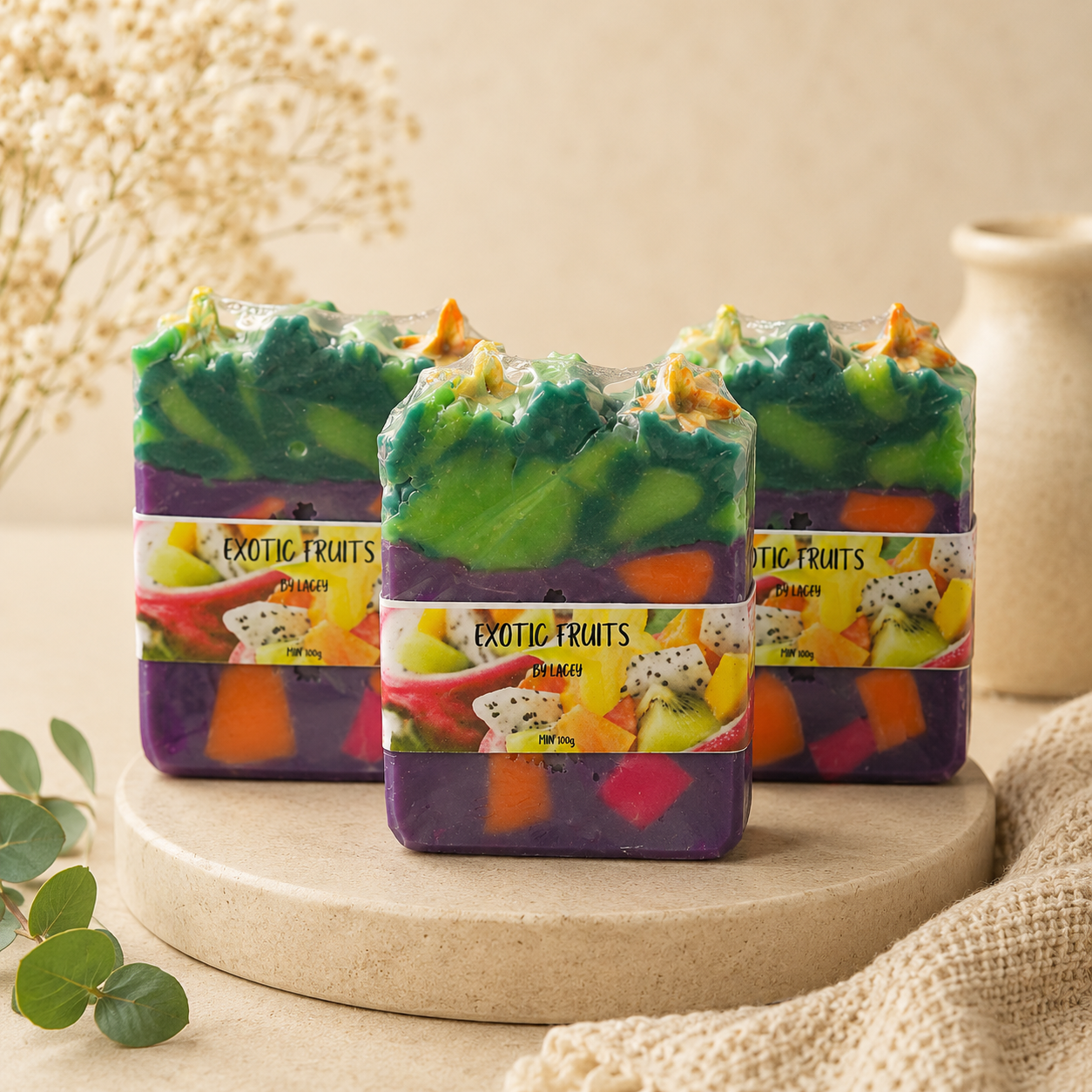 Colorful soap bars with 'Exotic Fruits' packaging on a wooden stand.