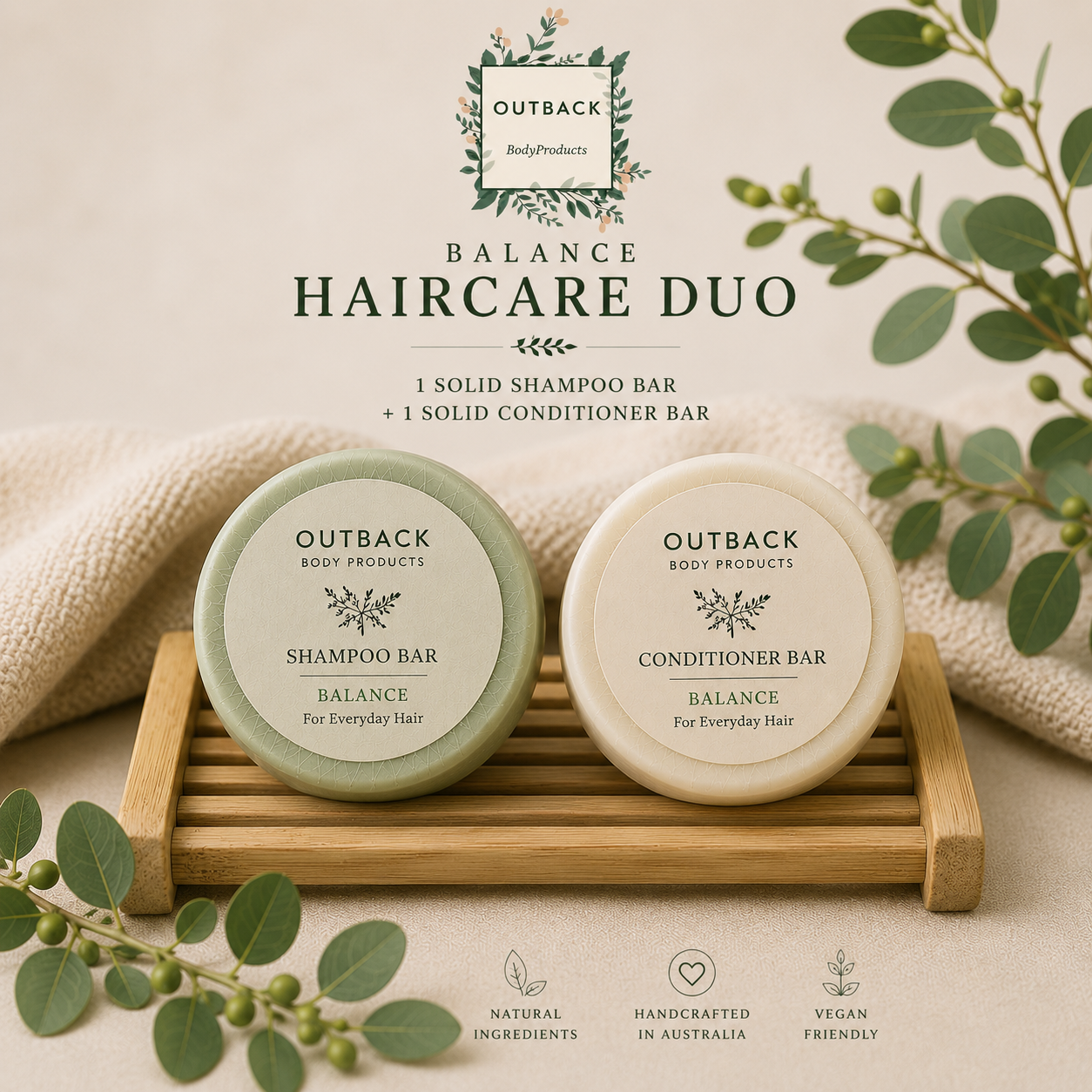 Outback Balance Haircare Duo with shampoo and conditioner bars on a wooden stand, surrounded by greenery.