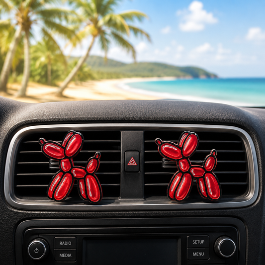 Red balloon dog air fresheners on a car vent with a beach background