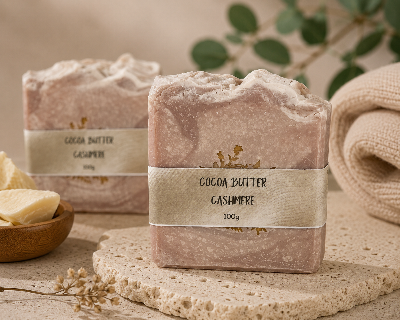 Cocoa Butter Cashmere soap bars on a textured surface with natural elements.