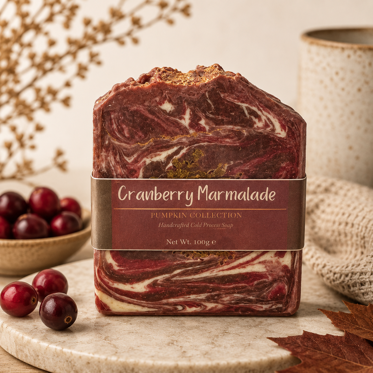 Cranberry Marmalade soap bar with a label, surrounded by cranberries and a woven basket on a neutral background.