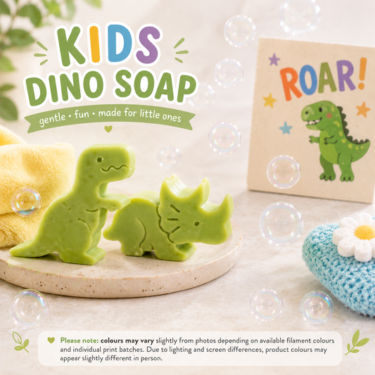 Two green dinosaur-shaped soaps on a stone surface with a 'ROAR!' card and bubble toy in the background.