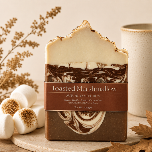 Toasted Marshmallow soap bar with packaging on a wooden surface with decorative elements.