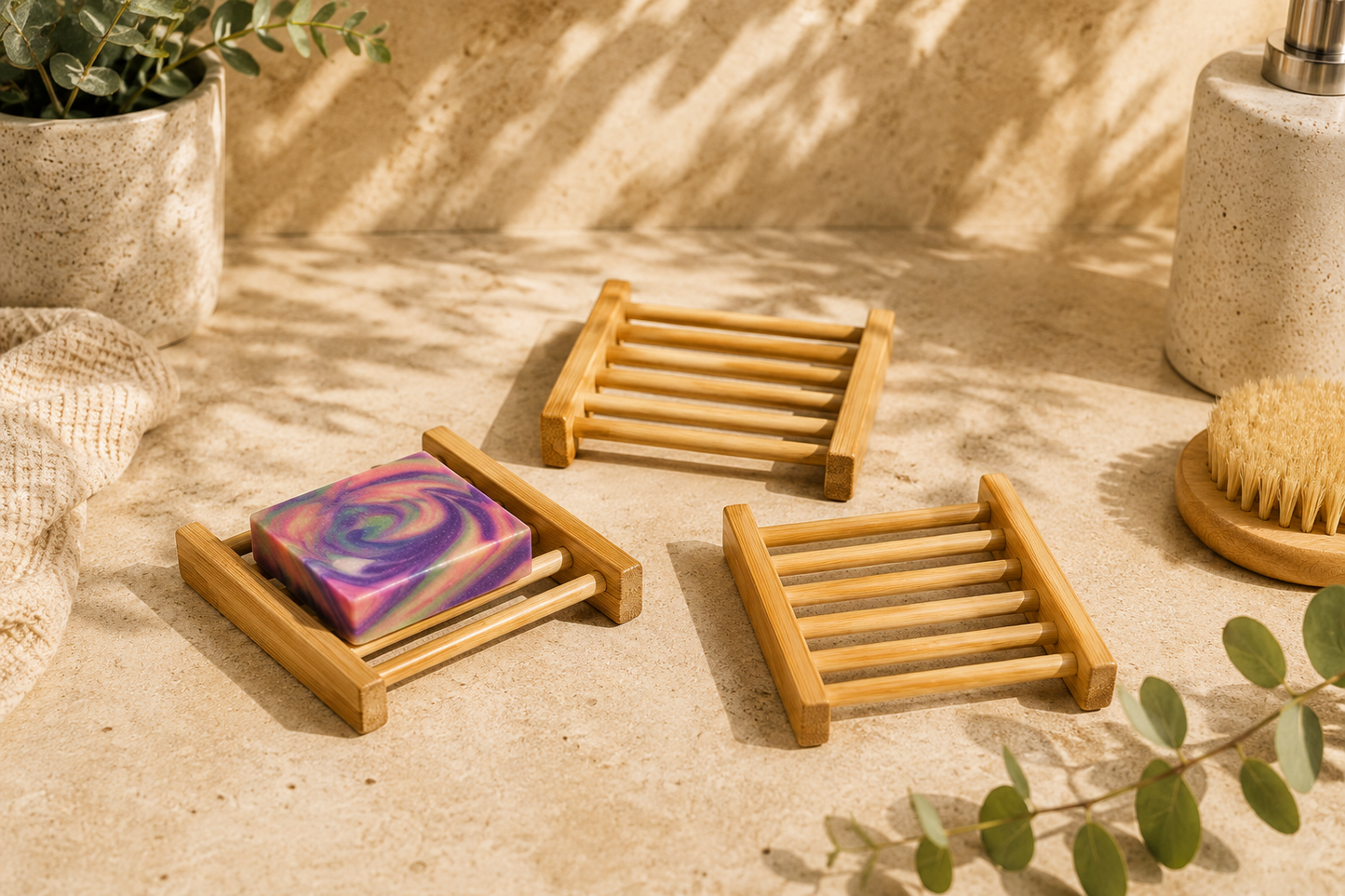 Bamboo soap dish with a colorful soap bar on a textured surface with plants and a candle.